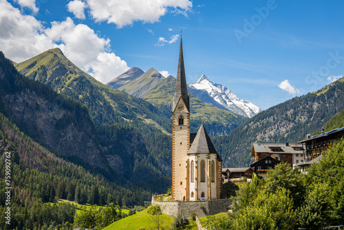 Heiligenblut, Carinthia, Austria, A scenic landscape photo of the Austrian municipality of Heiligenblut with St. Vincent Church in front of the Hohe Tauern mountain ridge © Photofex