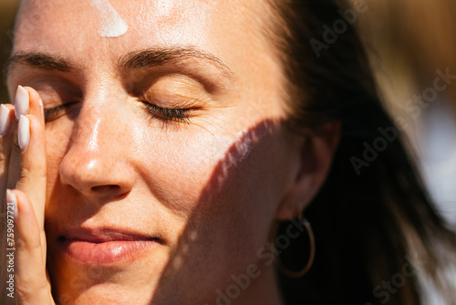 Woman Putting Sunscreen on Her Face