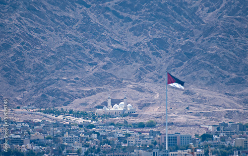 One of the biggest Jordanian mosque  - Al-Sharif Al-Hussein Bin Ali and highest National flag of Arabian Revolt, attractions are located above marine port of Aqaba city, Jordan