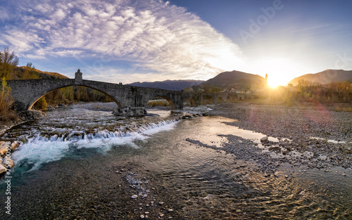 Aerial view of Bobbio town and Gobbo Bridge of Devil at sunset