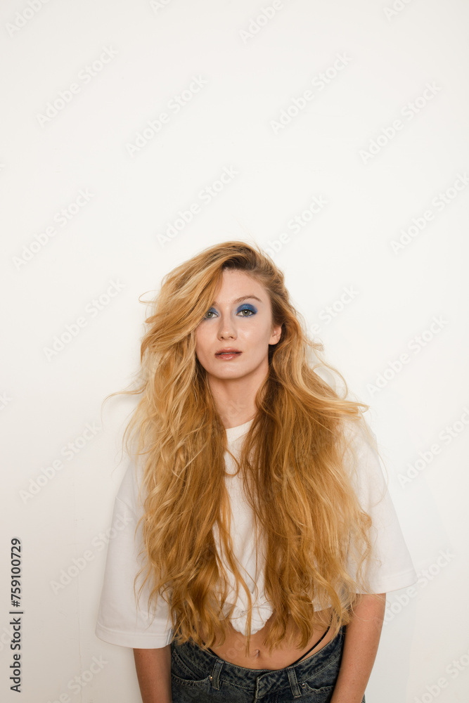 Woman posing on white studio wall background 