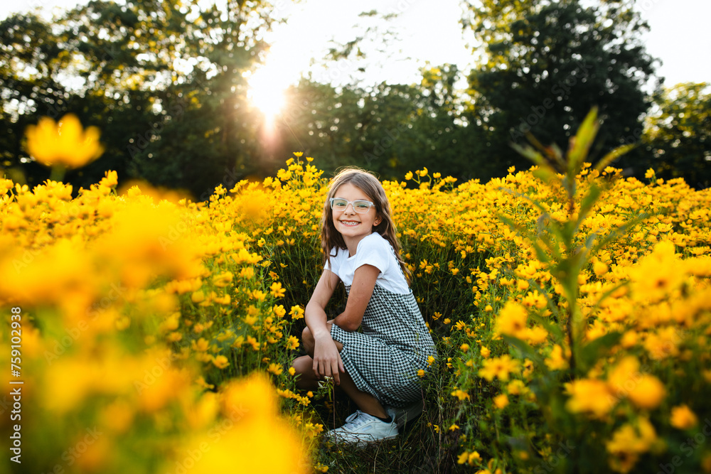 © Maria Manco/Stocksy - Preteen smiles at camera in wildflower field © Maria Manco/Stocksy - Preteen smiles at camera in wildflower field