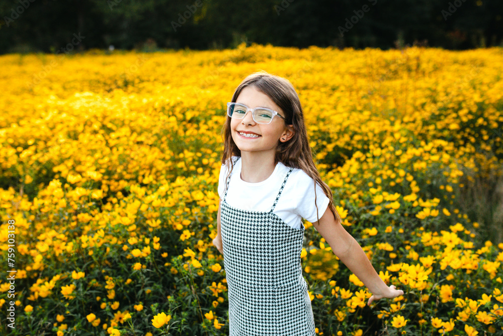 Preteen smiles at camera in wildflower field Preteen smiles at camera in wildflower field