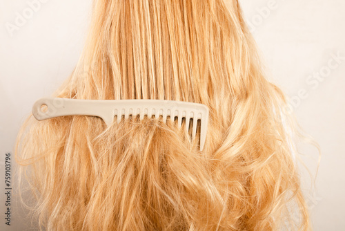 Comb tangled in long blonde hair 