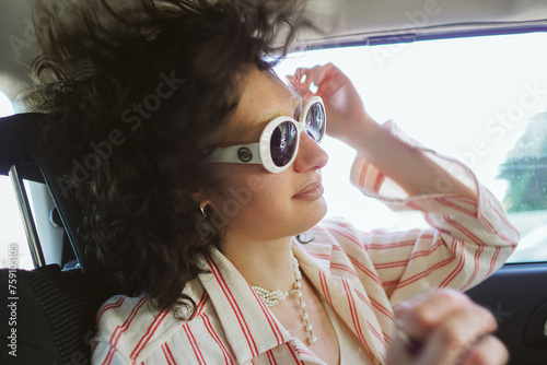 Portrait of a girl traveling in a car in a sunglasses photo