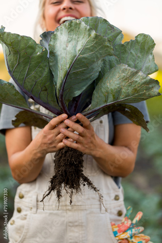 Woman holding plant with root