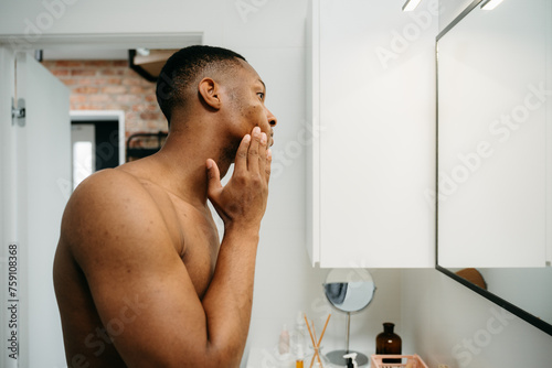 A man puts cream on his face photo