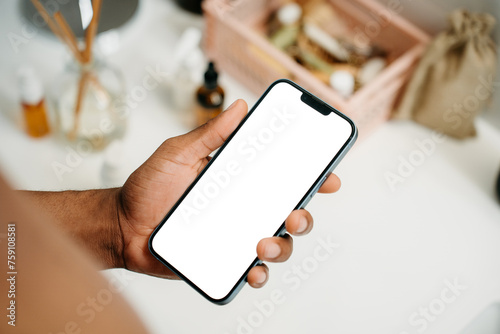 A phone with a white screen in a man's hand photo