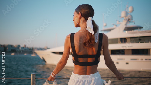 Cuadro en lienzo Tanned woman posing pier with luxury yacht close up
