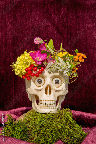 Still life with skull, flowers and berries photo