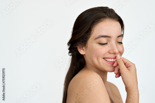 Happy Latin young woman with freckles on face isolated on white background. Smiling brunette girl with eyes closed advertising skincare  fresh healthy flawless skin care beauty cosmetic treatment.