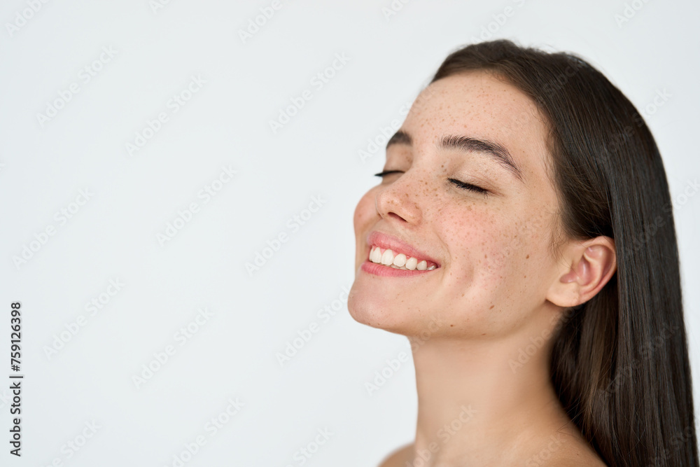 Happy brunette Latin girl isolated on white background. Smiling young adult woman with freckles on face posing with eyes closed advertising skincare, fresh healthy skin care beauty cosmetic treatment. Happy brunette Latin girl isolated on white background. Smiling young adult woman with freckles on face posing with eyes closed advertising skincare, fresh healthy skin care beauty cosmetic treatment.