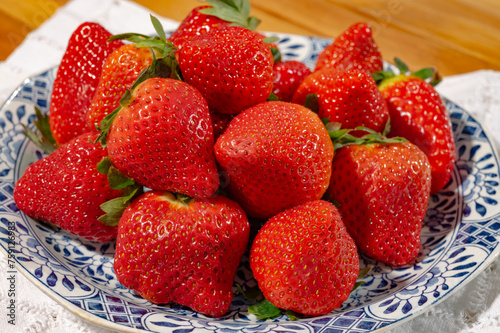 New harvest, plate with bio ripe red sweet strawberry from Spain