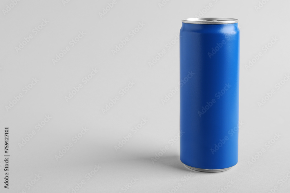 Energy drink in blue can on light grey background, space for text Energy drink in blue can on light grey background, space for text