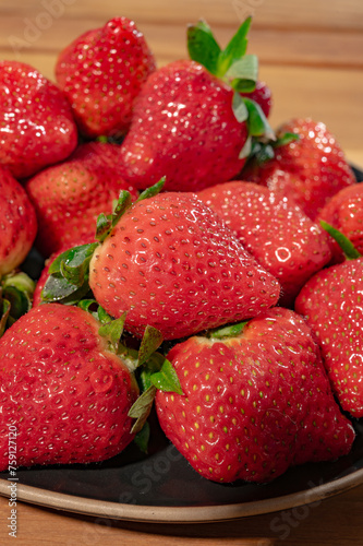 New harvest, plate with bio ripe red sweet strawberry from Spain