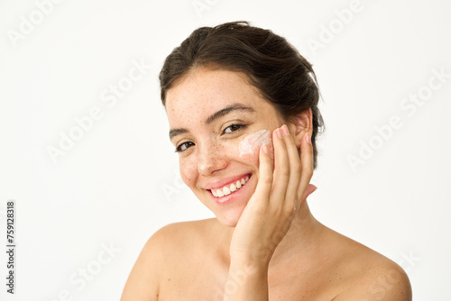 Happy Latin girl  young smiling woman model with freckles applying facial cream isolated on white background advertising healthy face skin care creme  skincare hydrating treatment  beauty portrait.
