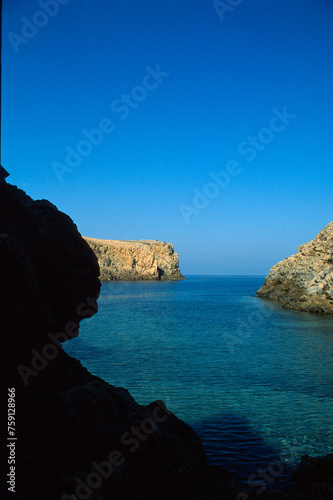 view of the sea at Cala Domestica beach and promontory, along the west coast of Sardinia, Buggerru, Italy photo