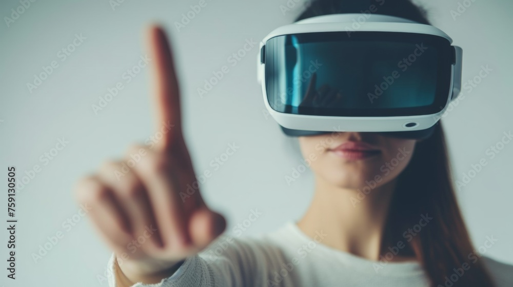 A person with headset touches a virtual screen in air with finger. A person with headset touches a virtual screen in air with finger.