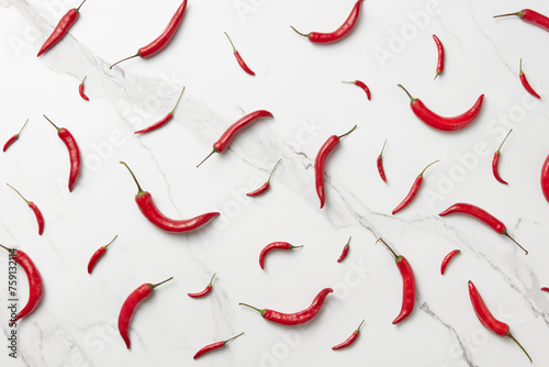 Seamless pattern of fiery chili peppers on marble background photo