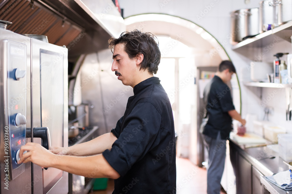 Focused chefs working in restaurant kitchen Focused chefs working in restaurant kitchen