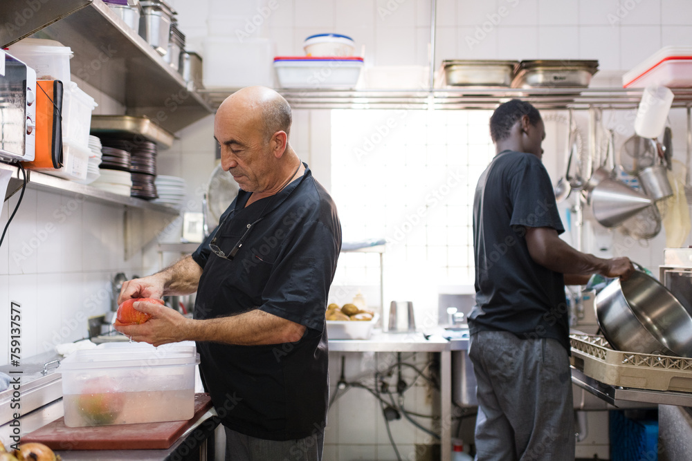 Diverse restaurant crew working in kitchen Diverse restaurant crew working in kitchen