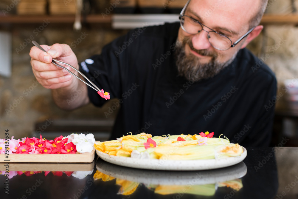 Smiling chef preparing creative dish Smiling chef preparing creative dish