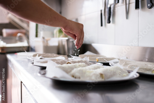 Anonymous chef preparing cannelloni photo