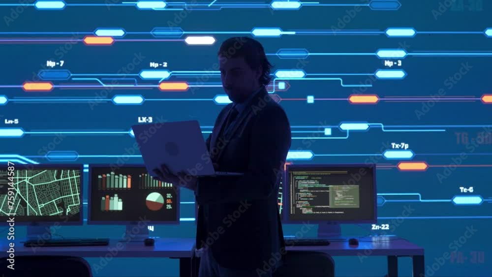 Technical support in control room. Silhouette of a man IT specialist with laptop at security office, big digital screen infrastructure monitoring infographic network data.