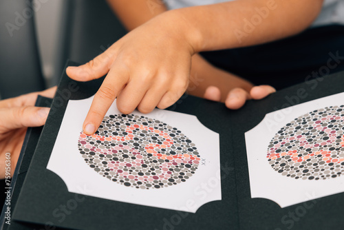 Crop child undergoing color blindness test in clinic photo