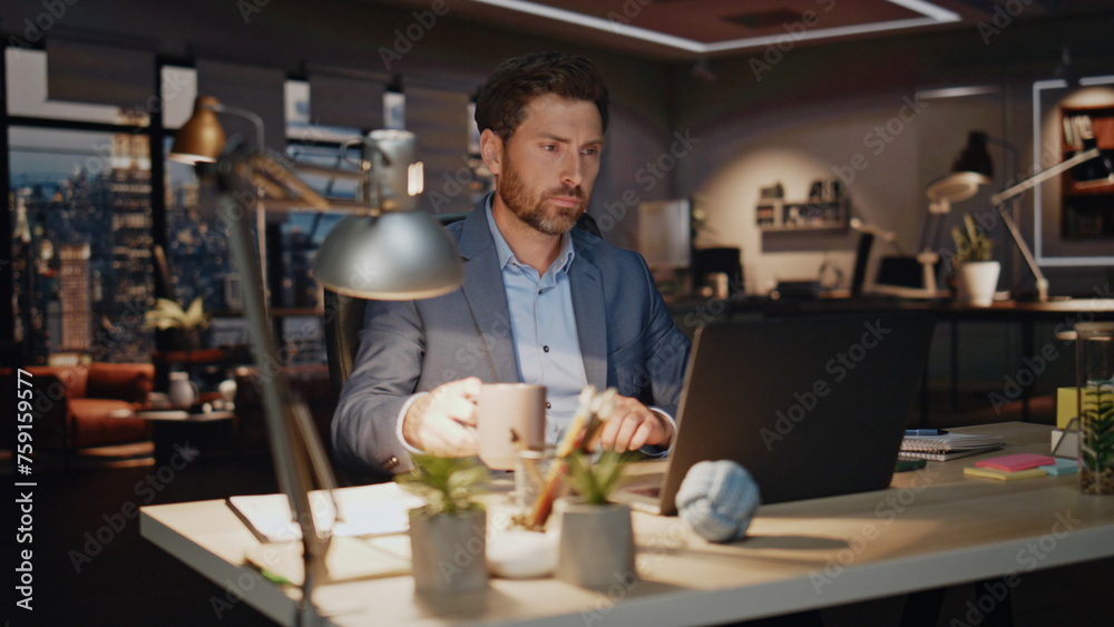 Fototapeta premium Business man drinking coffee late evening workplace closeup. Workaholic typing