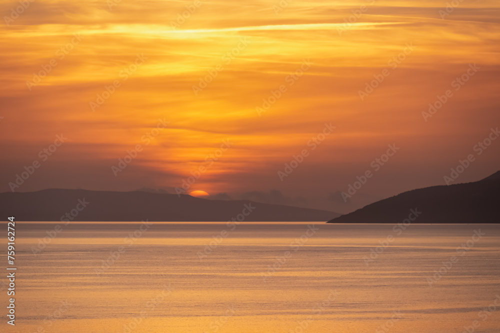 Idyllic sunset view of Dalmatian archipelago seen from coastal town Makarska, Split-Dalmatia, Croatia, Europe. Silhouette of islands. Coastline of Makarska Riviera, Adriatic Sea. Balkans in summer