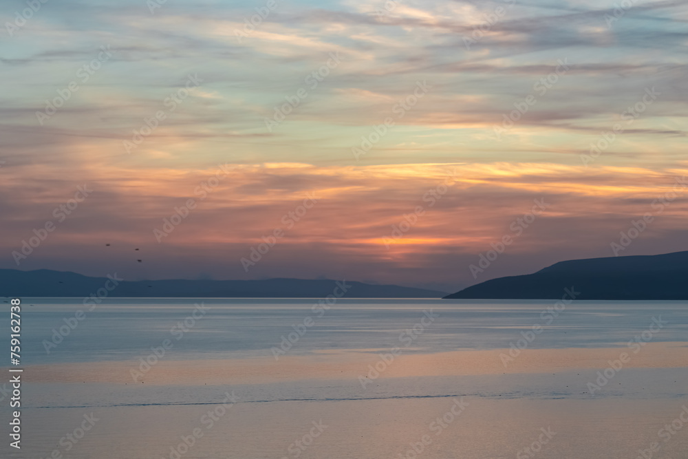 Idyllic sunset view of Dalmatian archipelago seen from coastal town Makarska, Split-Dalmatia, Croatia, Europe. Silhouette of islands. Coastline of Makarska Riviera, Adriatic Sea. Balkans in summer Idyllic sunset view of Dalmatian archipelago seen from coastal town Makarska, Split-Dalmatia, Croatia, Europe. Silhouette of islands. Coastline of Makarska Riviera, Adriatic Sea. Balkans in summer