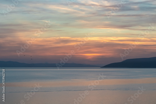 Idyllic sunset view of Dalmatian archipelago seen from coastal town Makarska, Split-Dalmatia, Croatia, Europe. Silhouette of islands. Coastline of Makarska Riviera, Adriatic Sea. Balkans in summer © Chris