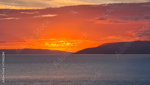 Idyllic sunset view of Dalmatian archipelago seen from coastal town Makarska, Split-Dalmatia, Croatia, Europe. Silhouette of islands. Coastline of Makarska Riviera, Adriatic Sea. Balkans in summer photo