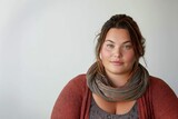 Casual plus-size female model standing with a scarf around her neck.