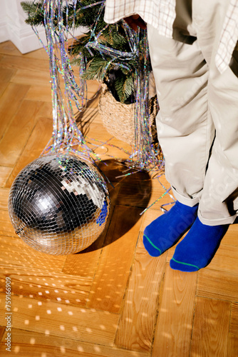 New Year's Eve party mood Disco ball and socks near the Christmas tree photo