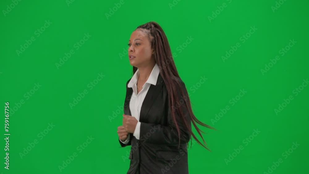 Female reporter isolated on chroma key green screen background. African American woman news host presenter in suit runs in front of camera. Half-turn. Female reporter isolated on chroma key green screen background. African American woman news host presenter in suit runs in front of camera. Half-turn.