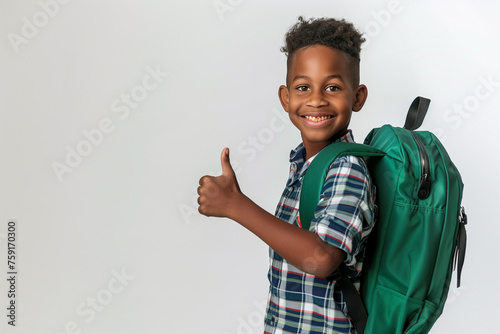 young african american boy showing thumb up with back pack isolated on white
