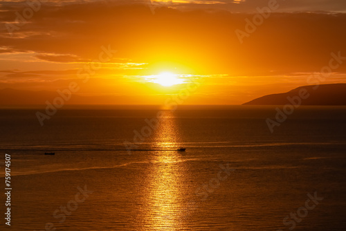 Silhouette of fishing boat with sunset view of Dalmatian archipelago seen from coastal town Makarska, Split-Dalmatia, Croatia, Europe. Coastline of Makarska Riviera, Adriatic Sea. Balkans in summer