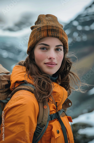 Woman Standing in Front of Mountain With Backpack