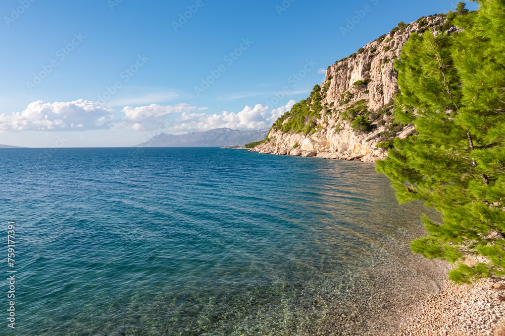 Scenic view of idyllic hiking trail along majestic cliffs between coastal villages Krvavica and Makarska, Dalmatia, South Croatia, Europe. Majestic Makarska Riviera, Adriatic Mediterranean Sea. Summer Scenic view of idyllic hiking trail along majestic cliffs between coastal villages Krvavica and Makarska, Dalmatia, South Croatia, Europe. Majestic Makarska Riviera, Adriatic Mediterranean Sea. Summer