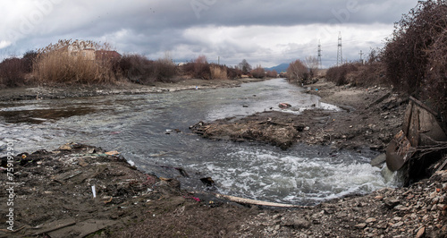 Major pollution of the waters of the river Crn Drim at the exit from tourist place Struga. Untreated water from the treatment plant flows into. The water level has been lowered by a nearby dam. photo