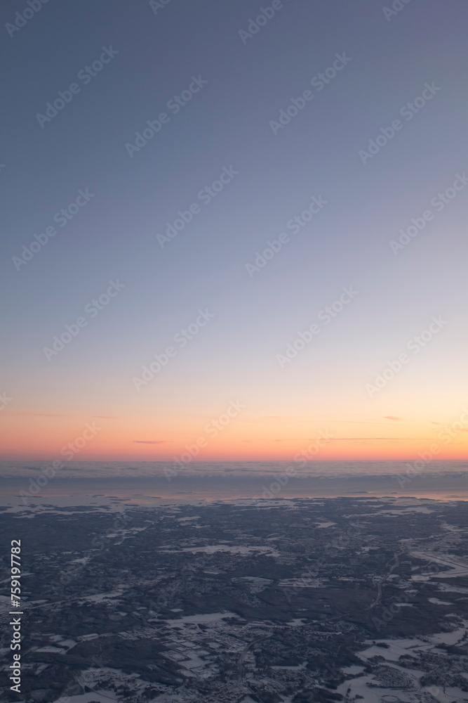 Orange sunset on a blue sky on a snowy winter lapland landscape in Rovaniemi, Finland