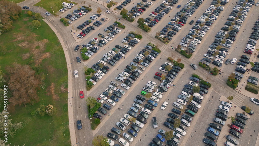 Aerial full town parking near green park. Diverse cars riding at crowded carpark
