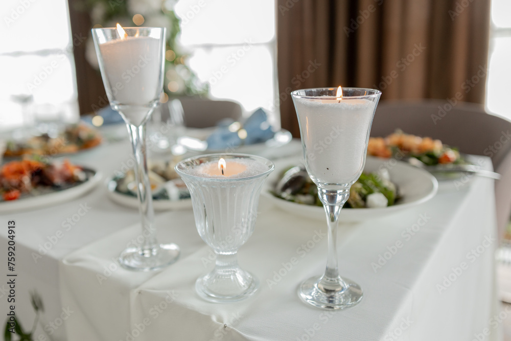 Elegant candlelit dinner, fine glassware, romantic ambiance