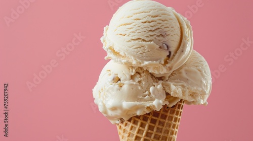 three scoops of ice cream in a waffle cone on a pink background with a pink wall in the background. photo