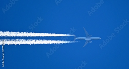 contrails chemtrails airplane smoke trail gases on blue sky background