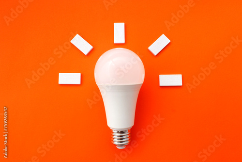 White light bulb with figures around it that express that a good idea has arisen photo