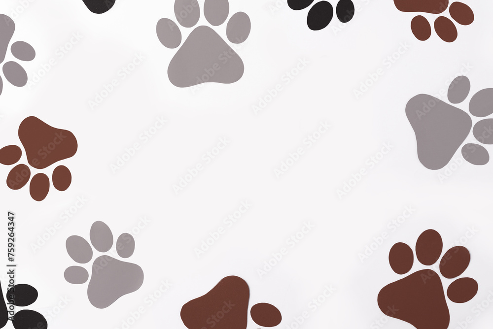 Fototapeta premium Pet paws on white background, dog paws pattern. National Puppy Day creative concept, top view