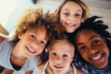 Four joyful multiethnic children smiling together, looking up with excitement. Diverse Group of Happy Children Smiling